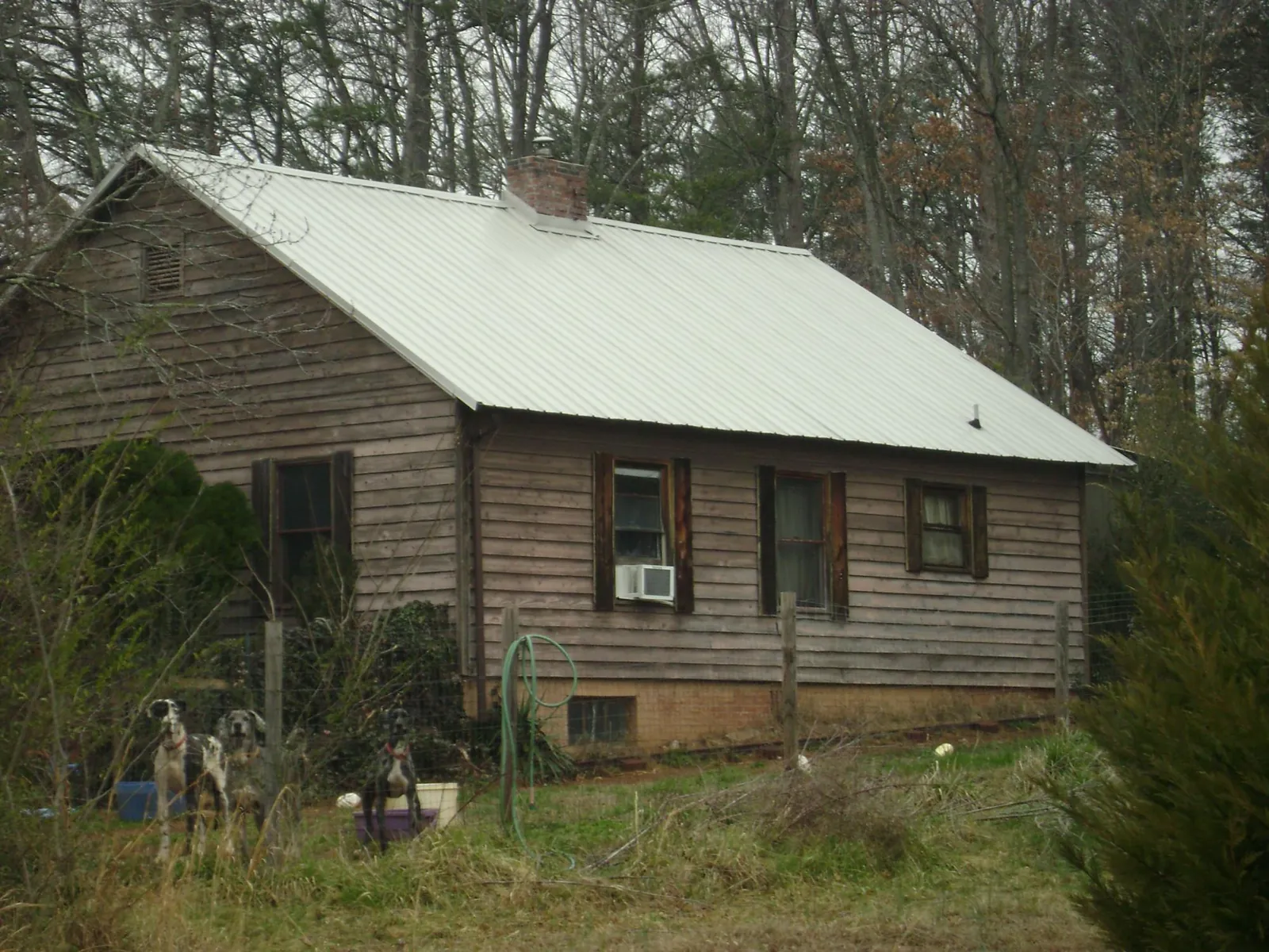 White metal roof on an old wood sided farmhouse, from a Metal Roof Installation job in Ivydale